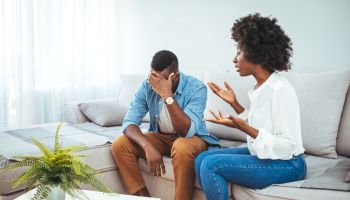 Unhappy young couple sit separate have problems in relationship